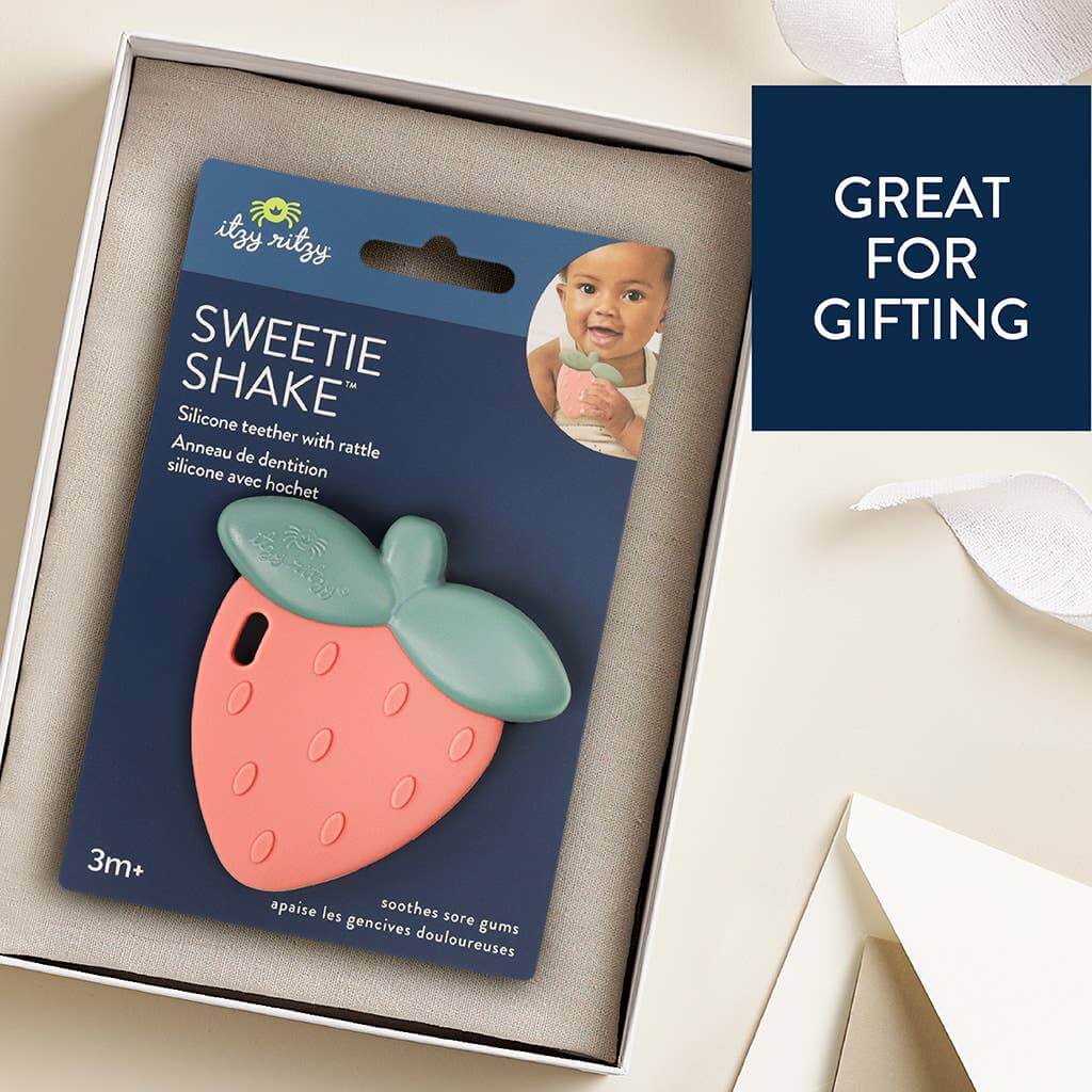 Strawberry Sweetie Rattle™ silicone teether in gift box, ideal for soothing sore gums, suitable for babies 3 months and older.